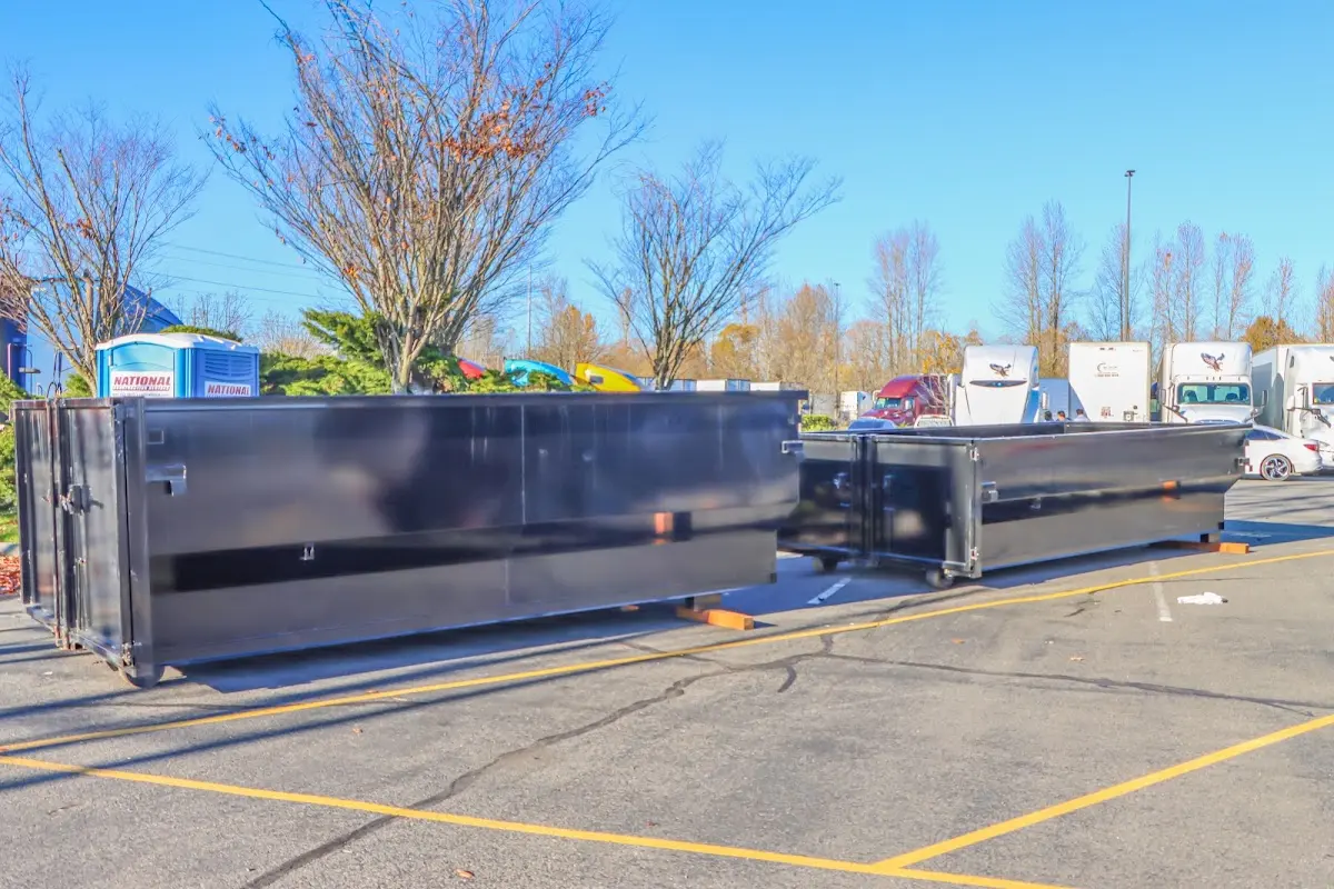 Professional dumpster rental service with roll-off container on residential driveway in Swoyersville